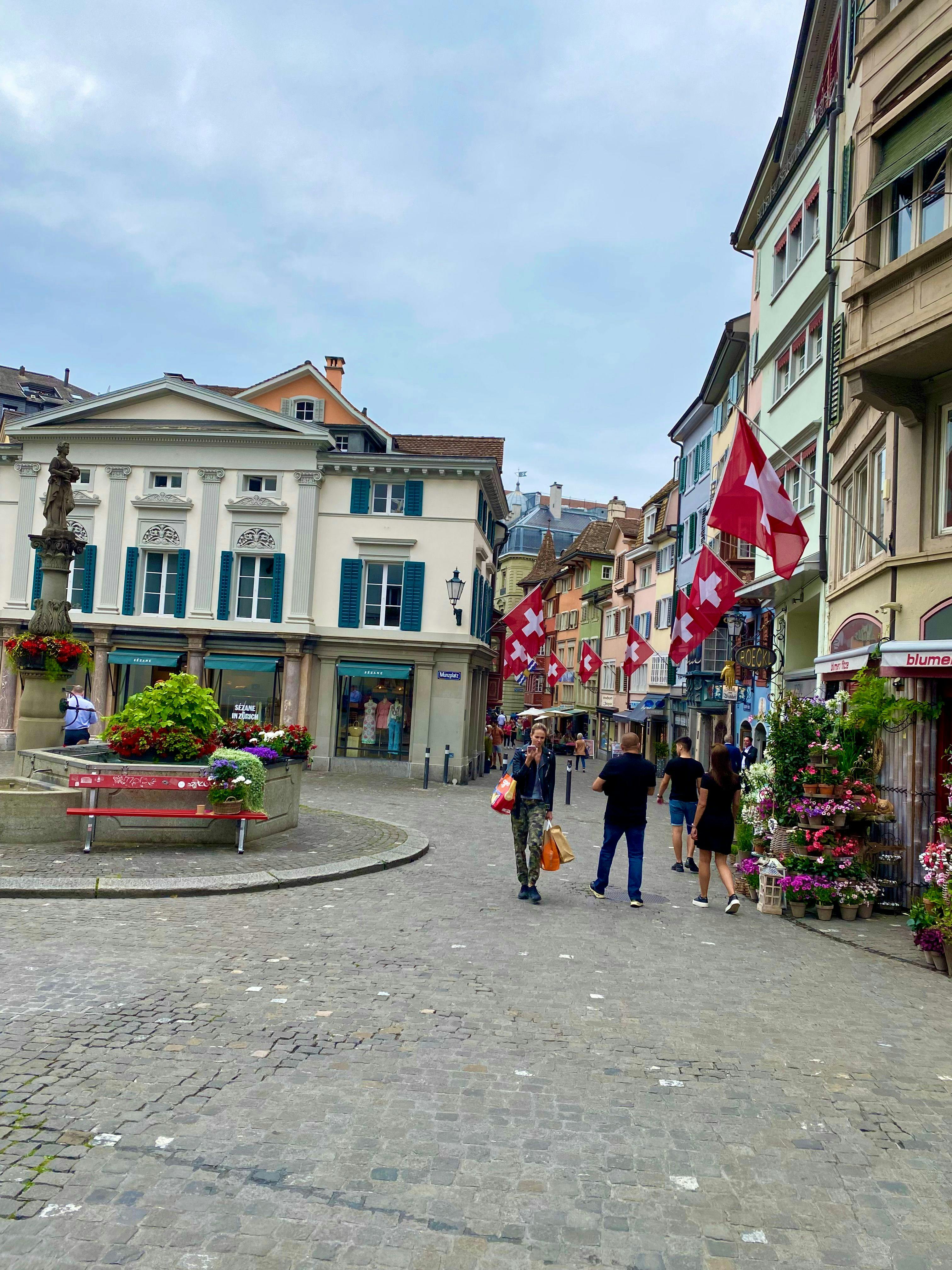 street with Swiss flags and fountain