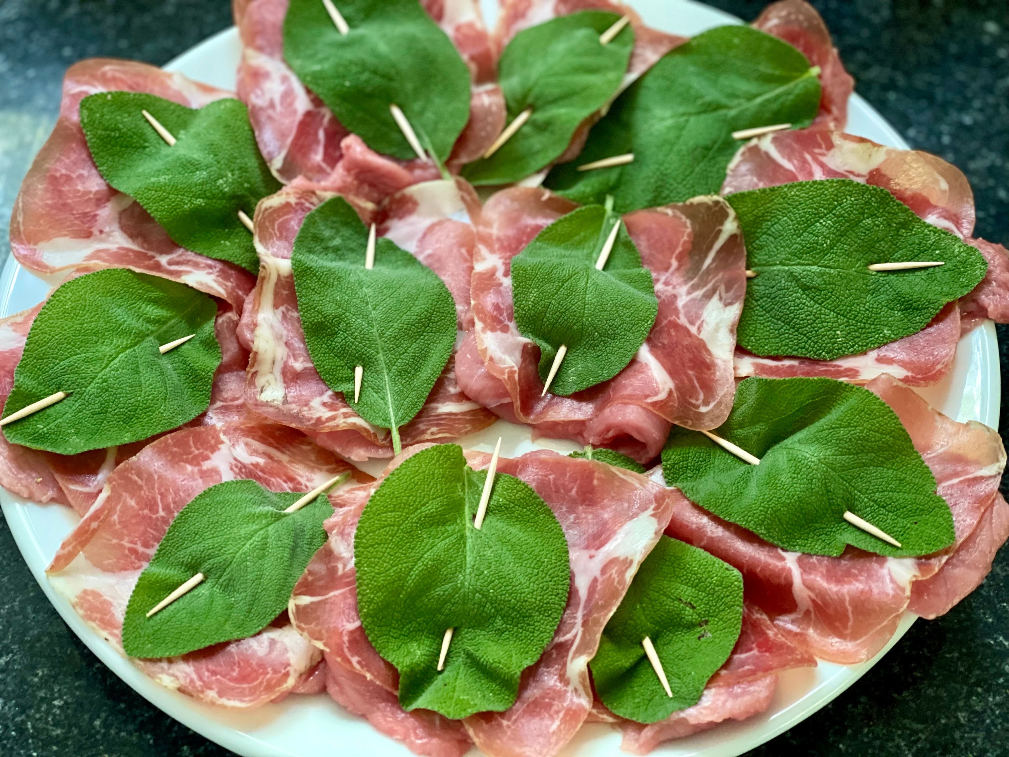 veal slices with prosciutto and sage leaves 