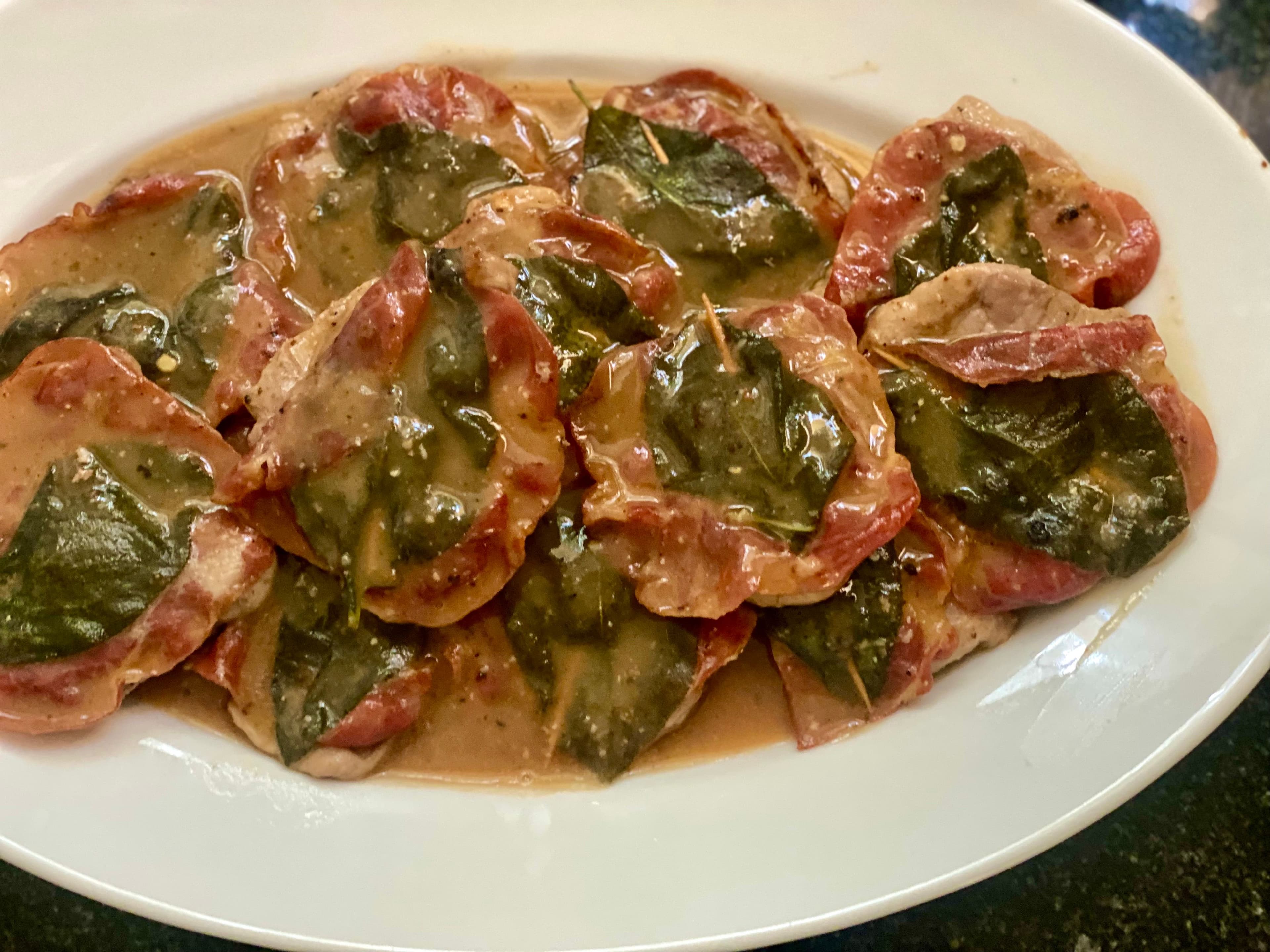 Cooked saltimbocca on a serving plate