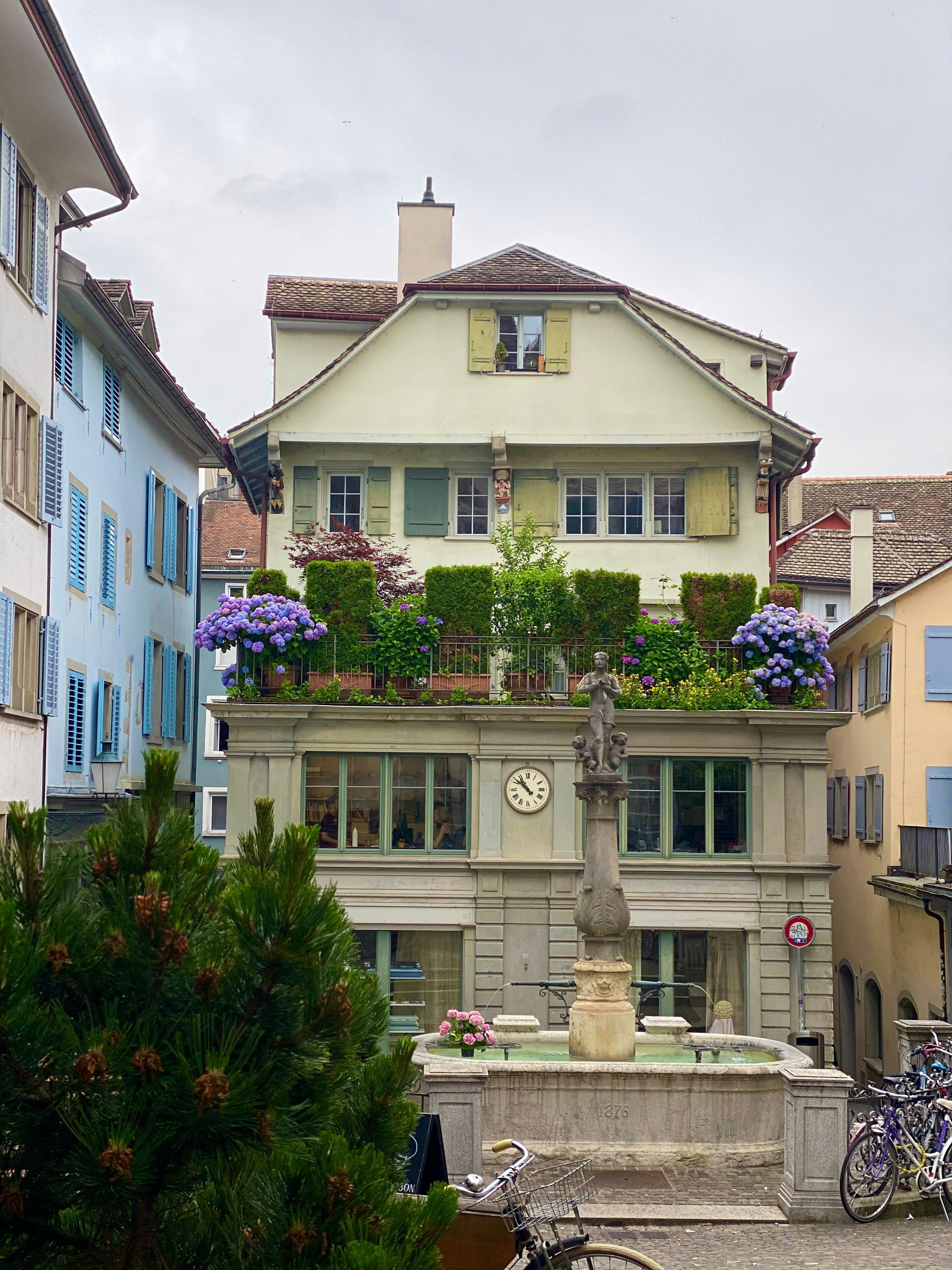 house with fountain in front