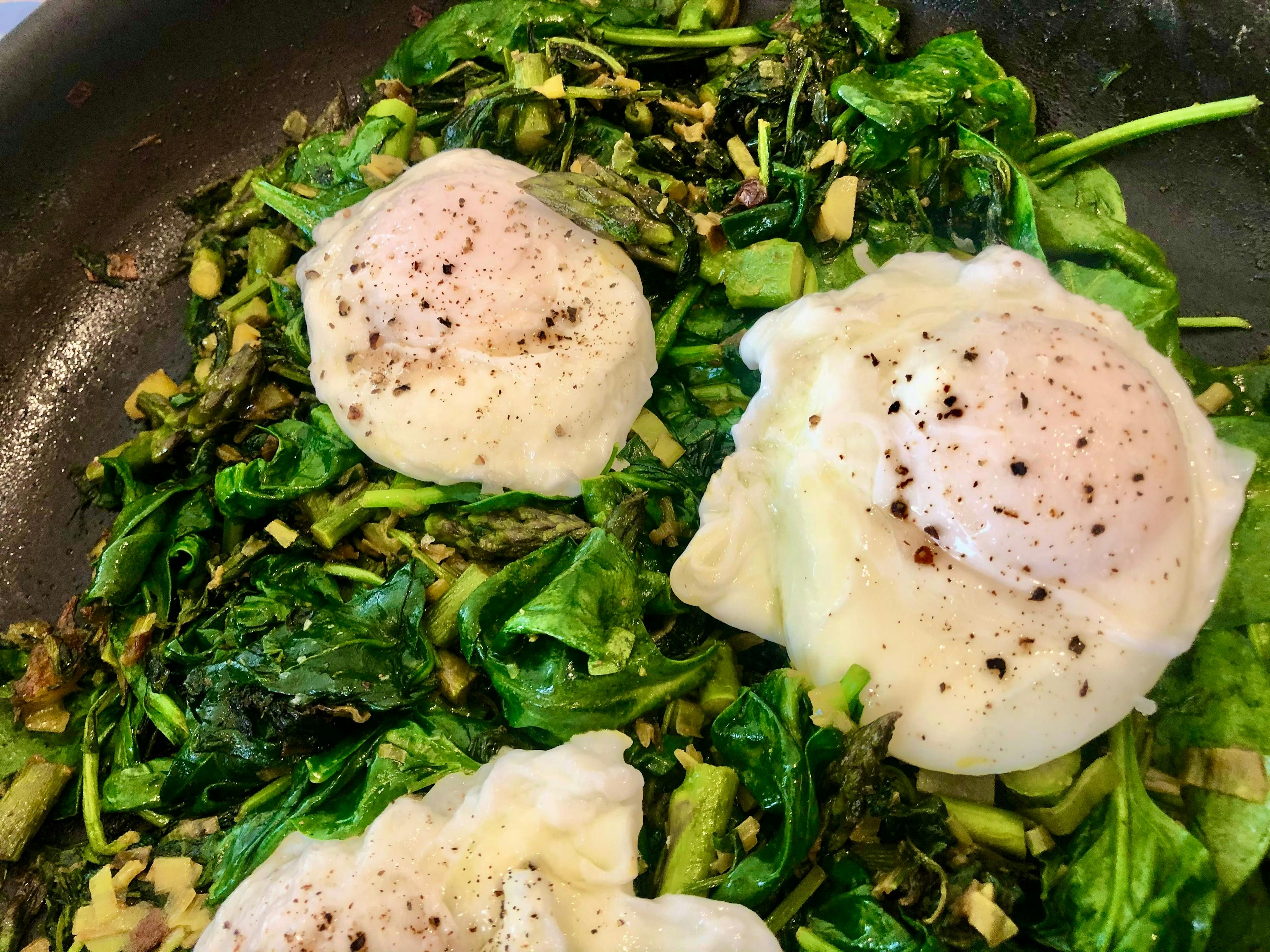 greens with poached eggs on top