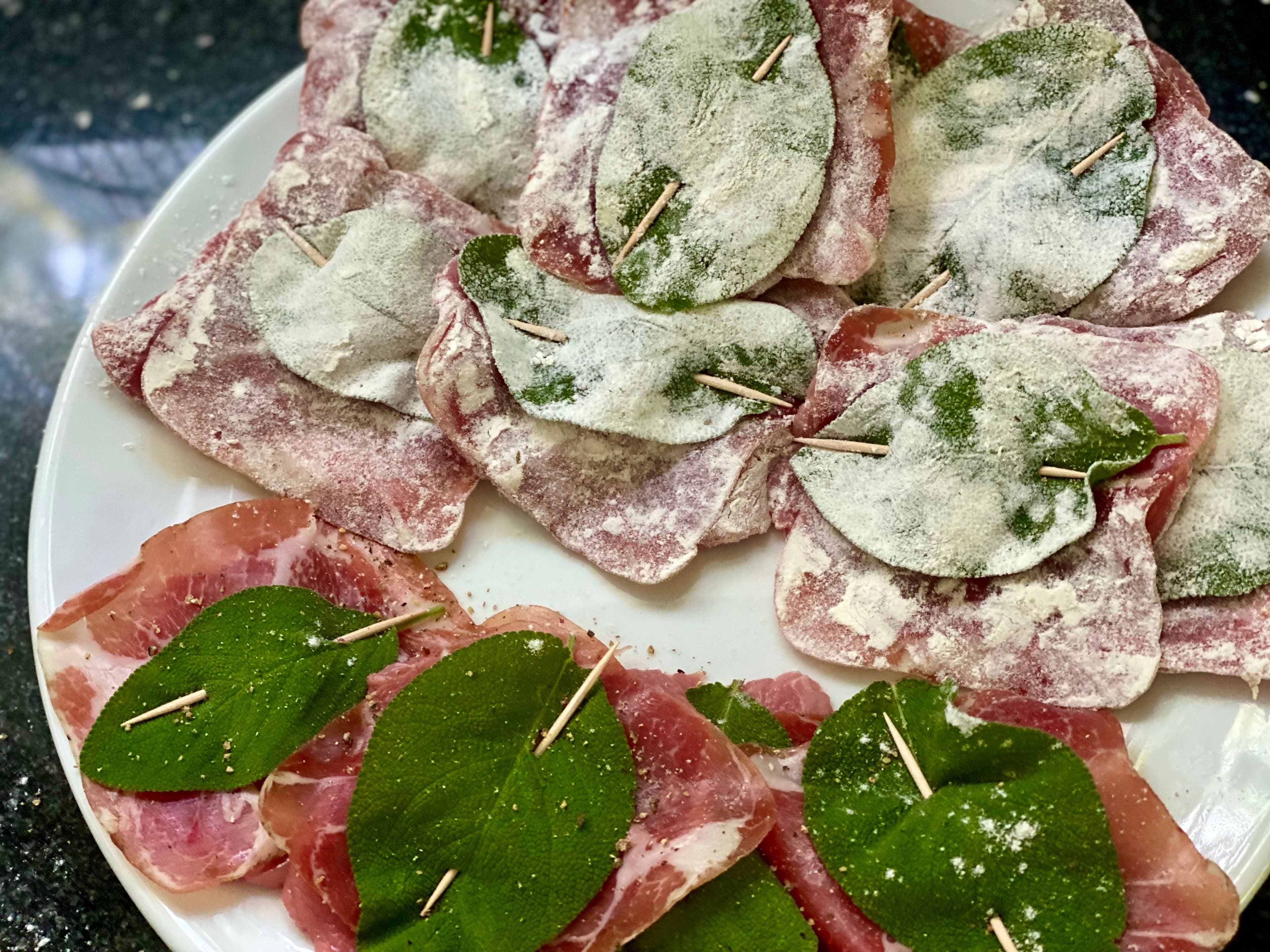 a plate with the scaloppine dusted with flour