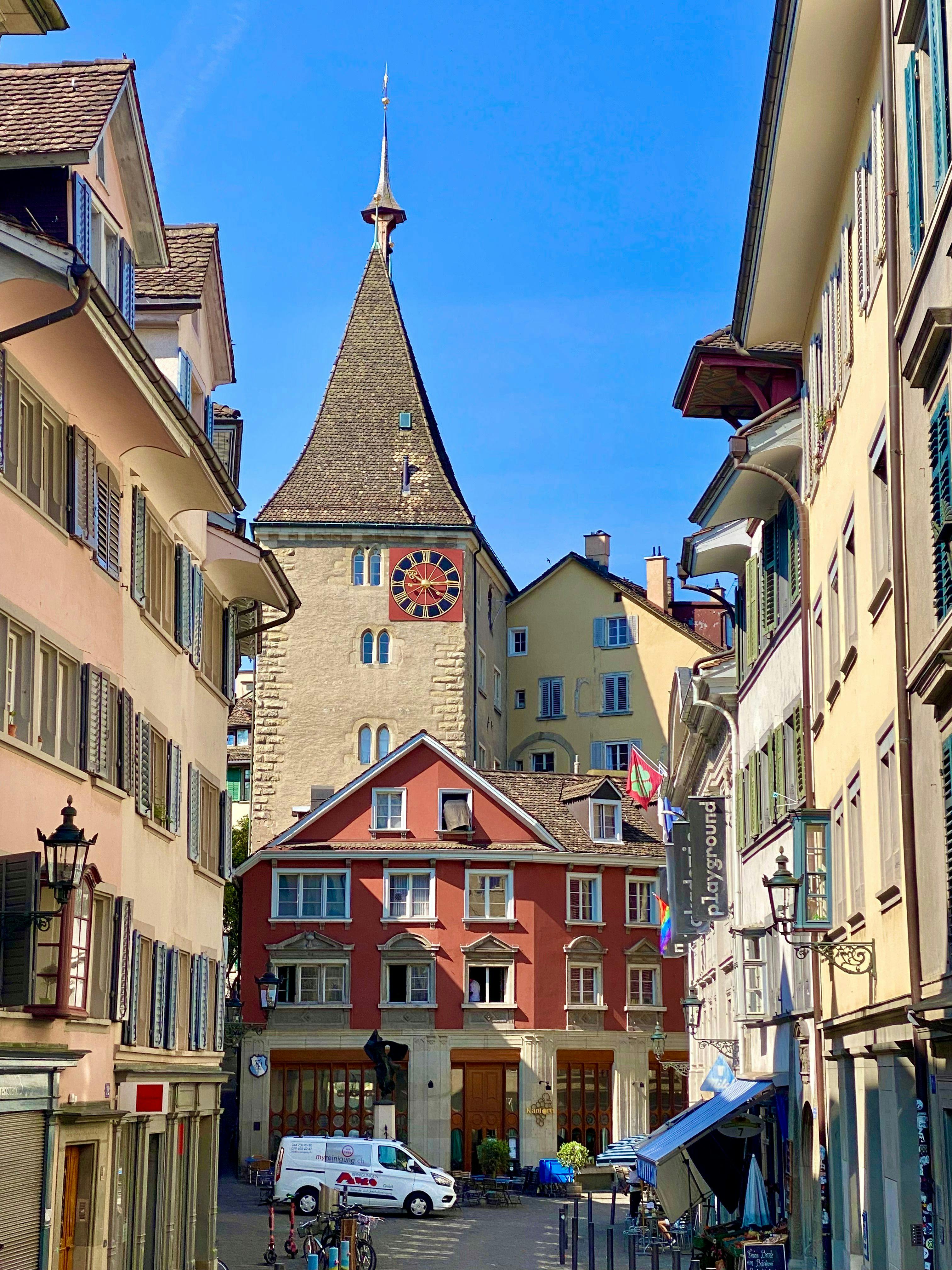 old tower with red house in front