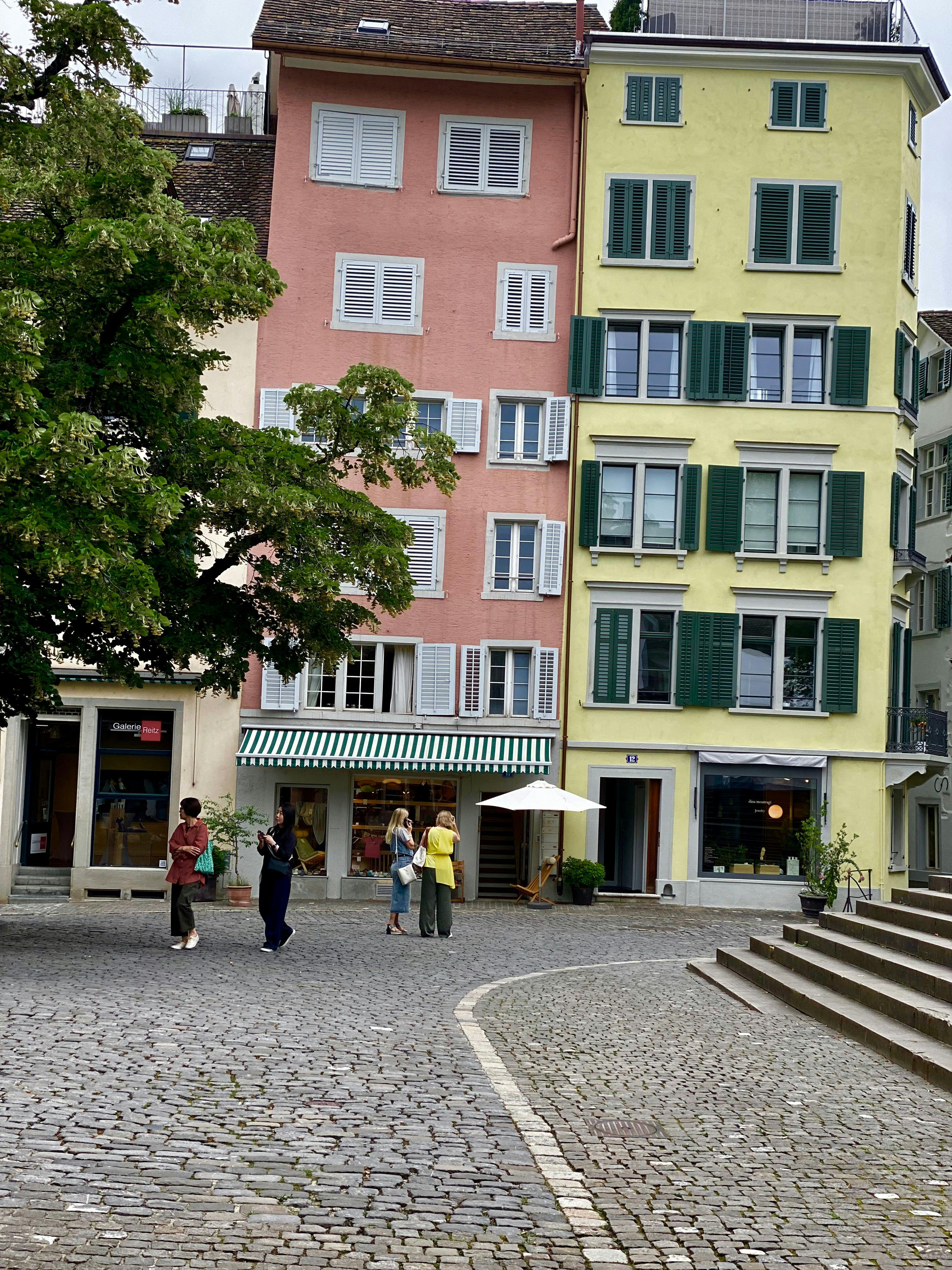 coloured buildings with 2 people in front